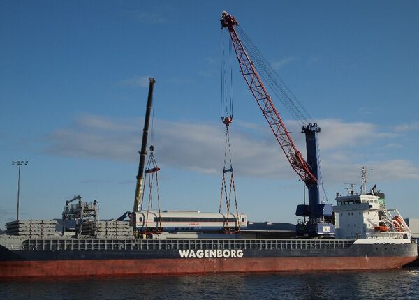 "Sapsan" high-speed train being lifted by two cranes onto vessel